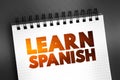 Learn Spanish text on notepad, concept background
