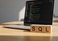 Learn sql database programming language tutorial for beginners with laptop on wooden desk background Royalty Free Stock Photo