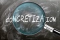 Learn, study and inspect Concretization. A magnifying glass enlarging word \'concretization\' written on a black Royalty Free Stock Photo