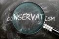 Learn, study and inspect conservatism - pictured as a magnifying glass enlarging word conservatism, symbolizes researching,