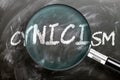 Learn, study and inspect cynicism - pictured as a magnifying glass enlarging word cynicism, symbolizes researching, exploring and Royalty Free Stock Photo