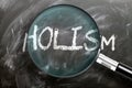 Learn, study and inspect holism - pictured as a magnifying glass enlarging word holism, symbolizes researching, exploring and Royalty Free Stock Photo