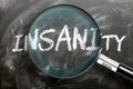 Learn, study and inspect insanity - pictured as a magnifying glass enlarging word insanity, symbolizes researching, exploring and