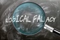 Learn, study and inspect Logical Fallacy. A magnifying glass enlarging word \'logical fallacy\' written on a bla Royalty Free Stock Photo