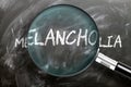 Learn, study and inspect melancholia - pictured as a magnifying glass enlarging word melancholia, symbolizes researching, Royalty Free Stock Photo