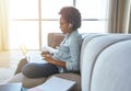 Learn today. Side view of focused teen girl wearing earphones using laptop, typing sitting on the couch while studying