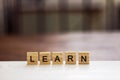 Learn word written on wood block. Word LEARN formed by wood alphabet blocks. Royalty Free Stock Photo