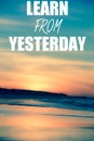 Learn from yesterday phrase on a background with Sunset sky colours on a beach Royalty Free Stock Photo