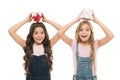 Learned how to gift wrap. Happy little girls holding gift boxes over head. Small children with gift packs on boxing day Royalty Free Stock Photo