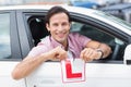 Learner driver smiling and tearing l plate