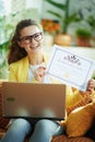 Learner woman with laptop showing certificate of graduation
