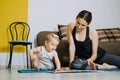 Learning Activities for Toddlers Baby. Mother reading book with cute Toddler baby daughter Royalty Free Stock Photo