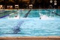 Learning of Asian boy practice swimming with foam board for the teaching at swimming pool. Royalty Free Stock Photo