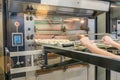 apprentice baker's hands putting in the baguettes for baking learning the baker's trade in a bakery Royalty Free Stock Photo