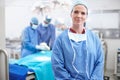 Learning from the best. Portrait of a confident mature female doctor wearing her hospital scrubs standing in an Royalty Free Stock Photo