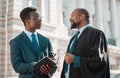 Learning from the best. two male lawyers talking in the city.