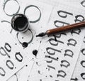 Learning calligraphy - paper with example and brush ink Royalty Free Stock Photo