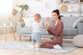 Learning Colors. Mom Showing Different Pencils To Her Baby Son At Home