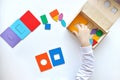 Learning colors and shapes. Children's wooden toy. The child collects a sorter. Educational logic toys for kid's.