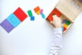 Learning colors and shapes. Children`s wooden toy. The child collects a sorter. Educational logic toys for kid`s. Children`s ha