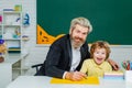 Learning concept. Father and son together schooling. Happy school kids at lesson. Home study. Royalty Free Stock Photo