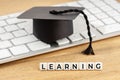Learning concept. Graduation cap on computer keyboard Royalty Free Stock Photo