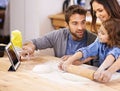 Learning, cooking and family in kitchen with tablet for recipe, guide and mom and dad with child in home. Baking, pizza Royalty Free Stock Photo