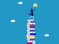 learning creates opportunities and wisdom for creative thinkers. Businesswoman on a high stack of books with a light bulb