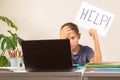 Learning difficulties, school, education, online remote learning concept. Sad kid sitting at table with laptop computer Royalty Free Stock Photo