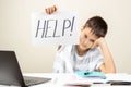 Learning difficulties, school, education, online remote learning concept. Tired frustrated boy sitting at table and Royalty Free Stock Photo