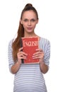 Learning English concept. Pretty girl holding a book. Royalty Free Stock Photo