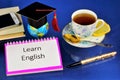 Learning English is the most important international language. On the student`s Desk notebook and pen for records, tea with lemon