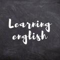 Learning English title on School Blackboard. Royalty Free Stock Photo