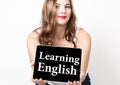 Learning english written on virtual screen. technology, internet and networking concept. beautiful woman with bare Royalty Free Stock Photo