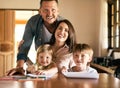 Learning is a family affair. a young family of four drawing and getting creative together at home. Royalty Free Stock Photo