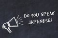 Learning foreign languages concept. Chalk symbol of loudspeaker with phrase do you speak japanese