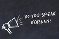 Learning foreign languages concept. Chalk symbol of loudspeaker with phrase do you speak korean Royalty Free Stock Photo