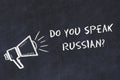 Learning foreign languages concept. Chalk symbol of loudspeaker with phrase do you speak russian