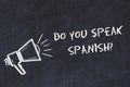Learning foreign languages concept. Chalk symbol of loudspeaker with phrase do you speak spanish Royalty Free Stock Photo