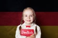 Learning german language concept with happy child girl