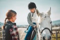 Learning, hobby and girl on a horse with a woman for fun activity in the countryside of Italy. Happy, animal and teacher Royalty Free Stock Photo