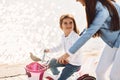 Learning how to drive. Mother with her young daughter is with bicycle outdoors together Royalty Free Stock Photo