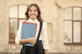 Learning language. Cute smiling child hold book. Little girl school student. Knowledge day. Hooked on learning. School