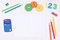 Learning maths. Kid`s desk with blank notebook, colorful pencils, numbers and a calculator