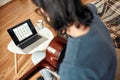 Learning music online. Rear view of a young man watching video tutorial and practicing guitar chords at home. Self Royalty Free Stock Photo