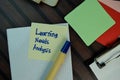 Learning Needs Analysis write on sticky notes isolated on Wooden Table