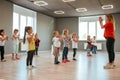 Learning a new dance. Group of little boys and girls dancing while having choreography class in the dance studio. Dance
