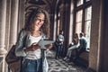 Beautiful female student preparing to lessons on digital tablet. Royalty Free Stock Photo