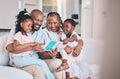 Learning, reading book and black children with grandparents on sofa in home living room. African family, storytelling