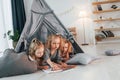 Learning to draw. Girls is laying down in the tent. Group of children is together at home at daytime Royalty Free Stock Photo